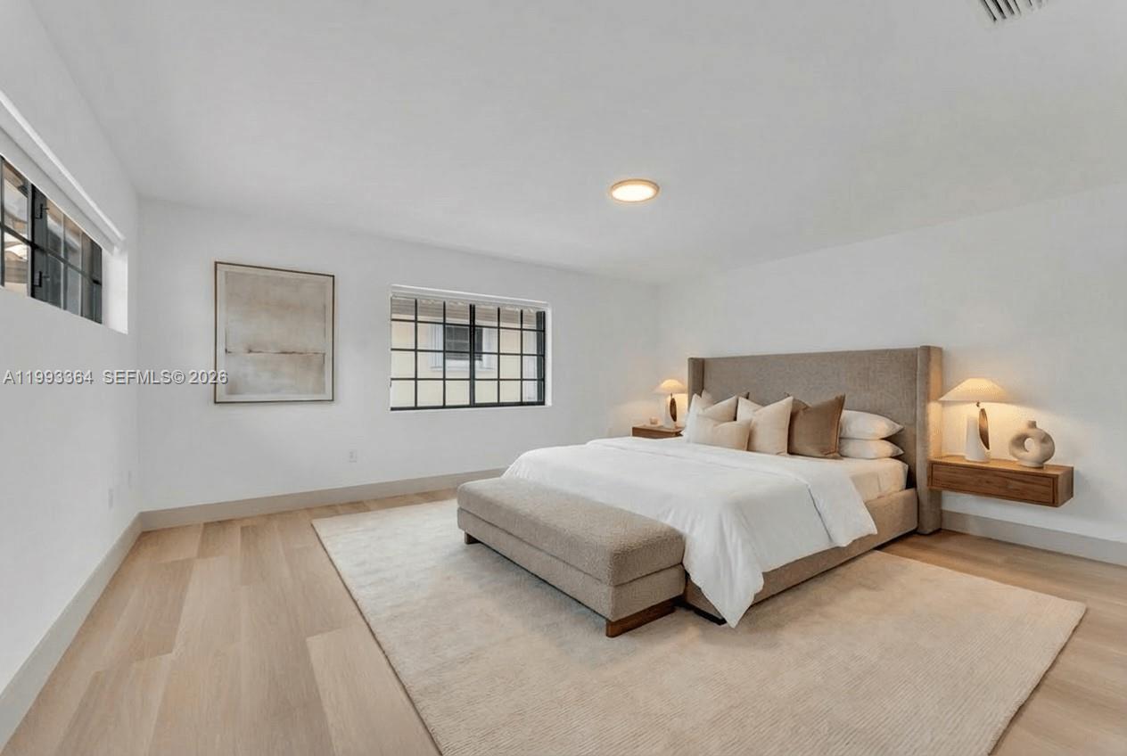 456 Southwest 20th Road, Unit 458 Miami, FL 33129 - Photo 15 of 37 a bedroom with a bed and wooden floor