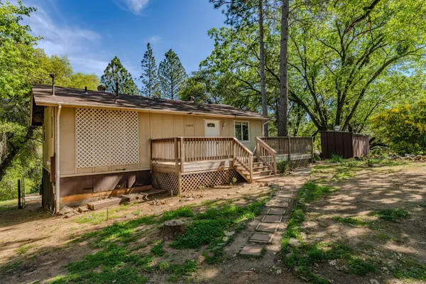 a backyard of a house with table and chairs