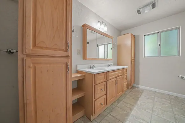 a bathroom with a granite countertop sink and a mirror