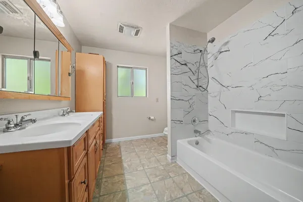 a bathroom with a bathtub and a sink