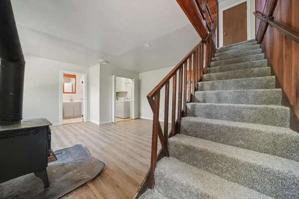 an empty room with wooden floor and a window
