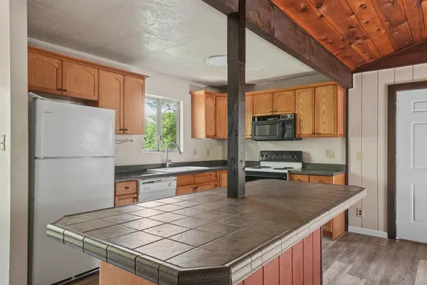 a kitchen with a refrigerator a stove a sink and a microwave