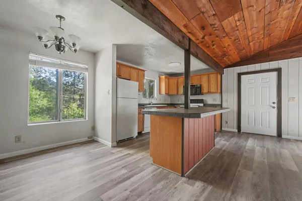 a kitchen with stainless steel appliances granite countertop a stove a sink and a refrigerator