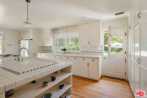 a view of a green field with wooden fence