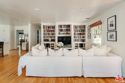 a spacious bedroom with a bed and a large window