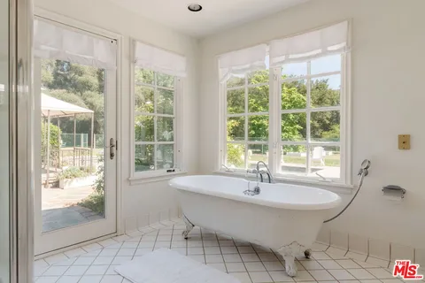 a bedroom with a bed and a windows