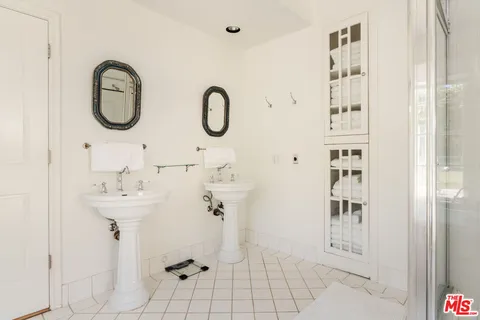 a spacious bedroom with a bed and wooden floor