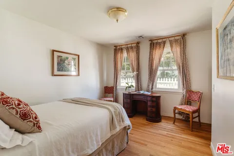 a dining room with furniture a large window and a fireplace