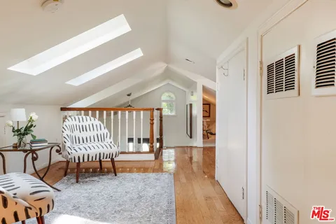 a living room with furniture a piano and a window