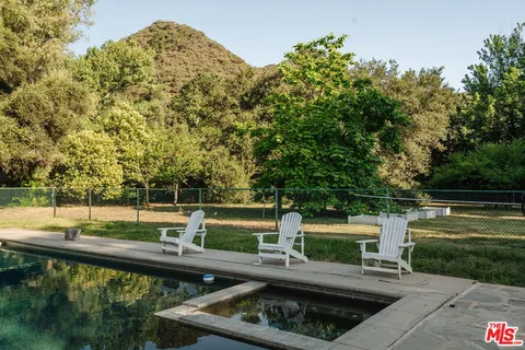 an aerial view of a house with a yard and garden