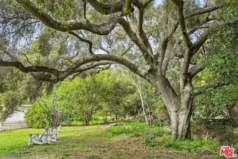 a view of a house with a yard and a garden