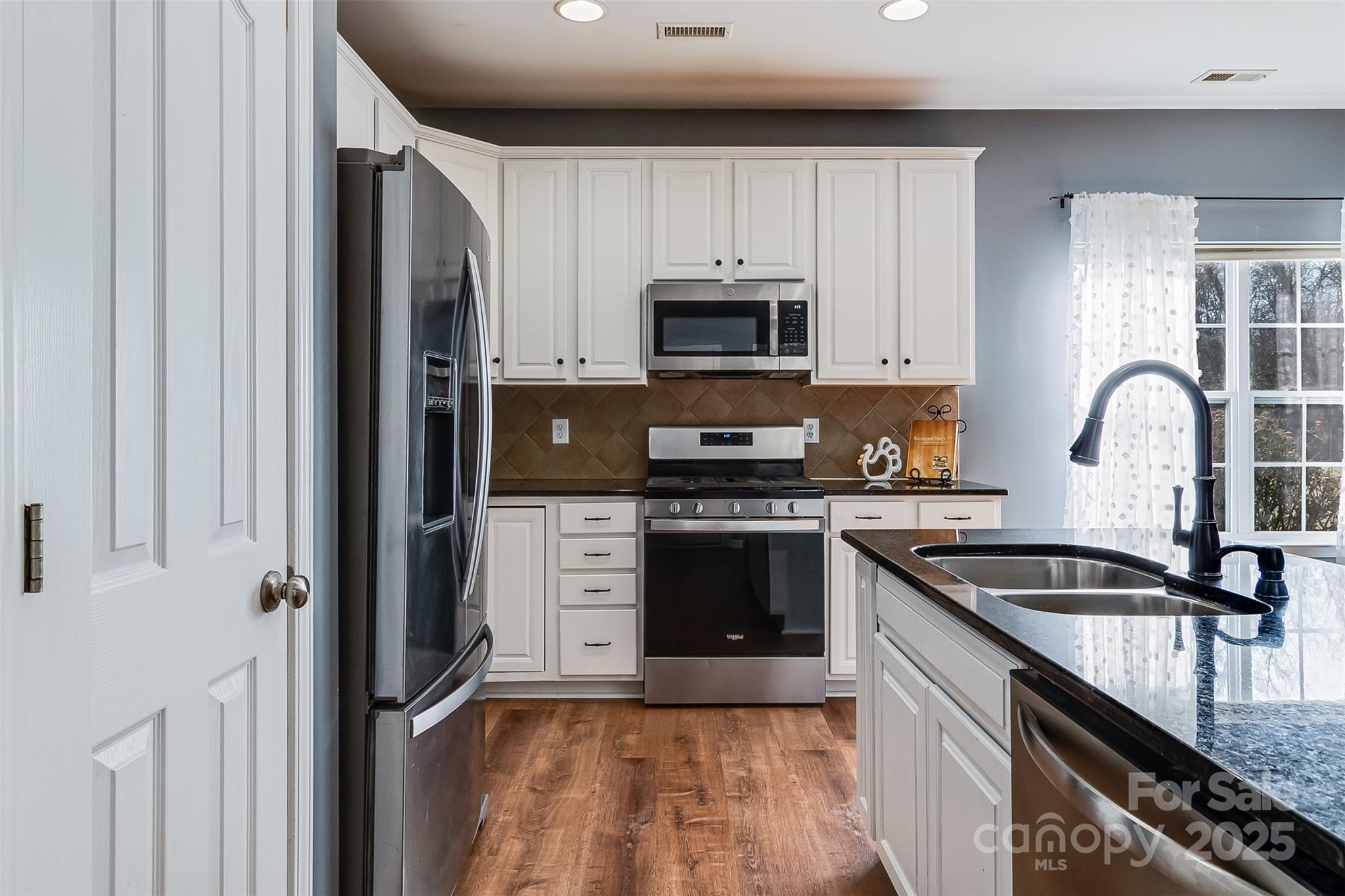 224 Morning Dew Lane Mount Holly, NC 28120 - Photo 11 of 48 a kitchen with granite countertop a refrigerator stove and sink