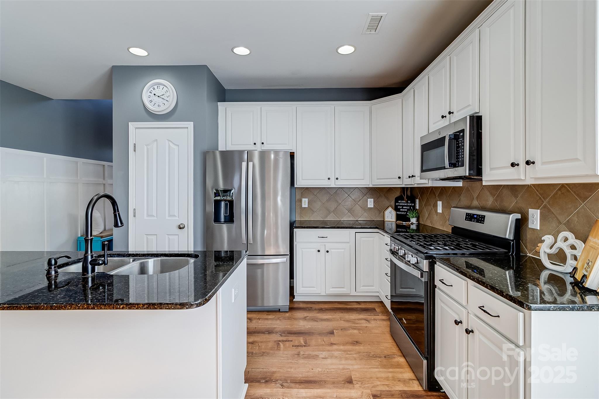 224 Morning Dew Lane Mount Holly, NC 28120 - Photo 12 of 48 a kitchen with stainless steel appliances granite countertop a sink stove and refrigerator