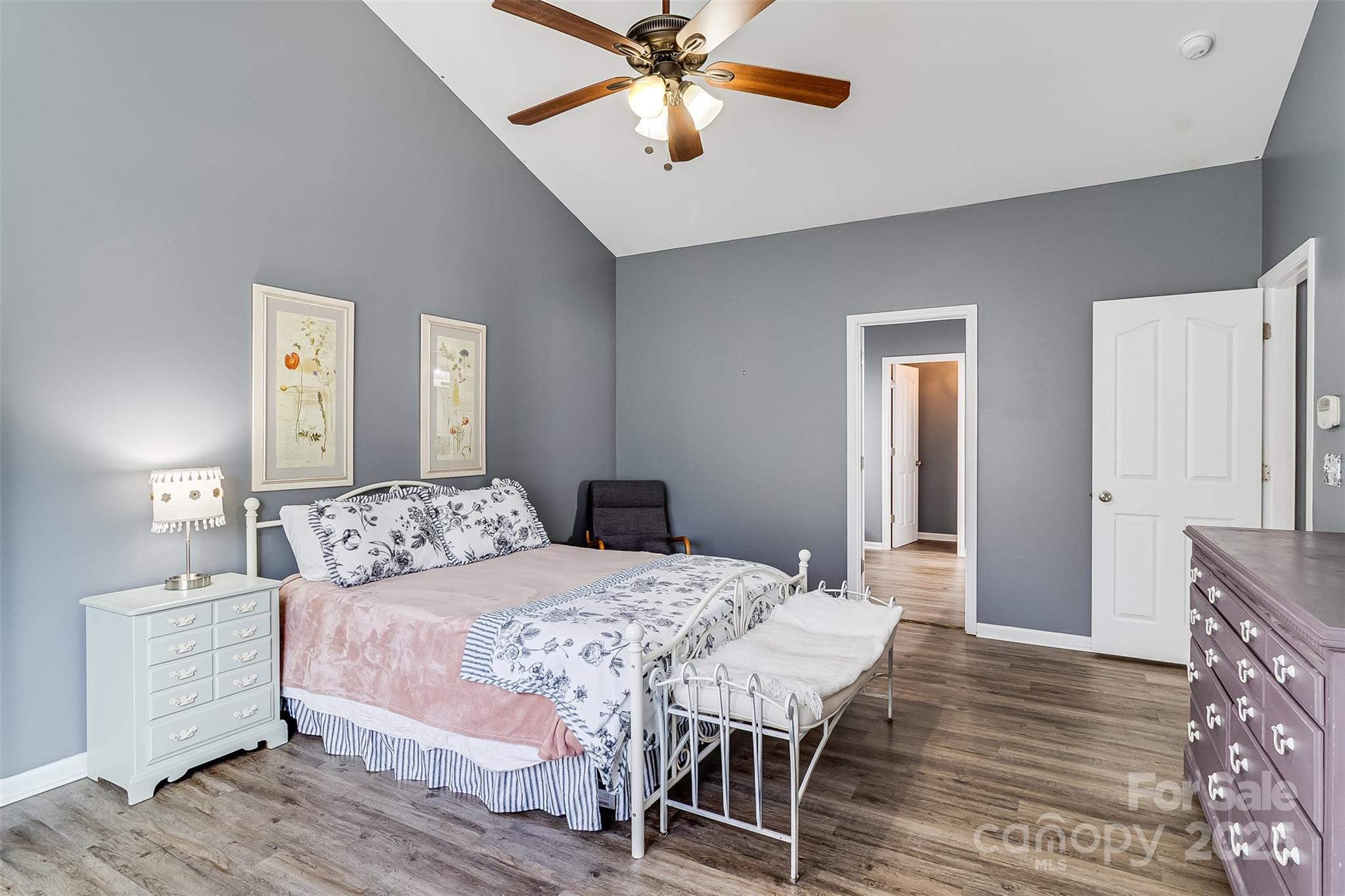 224 Morning Dew Lane Mount Holly, NC 28120 - Photo 20 of 48 a bedroom with a bed a chandelier and a dresser