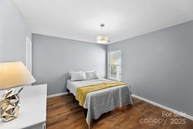 a bedroom with a bed and a lamp