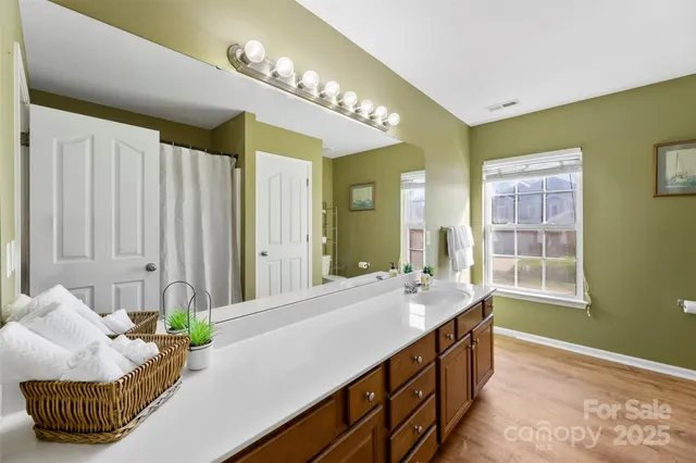 a bathroom with a double vanity sink and a mirror