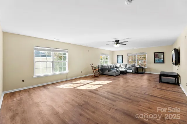 a view of a livingroom with furniture nad wooden floor