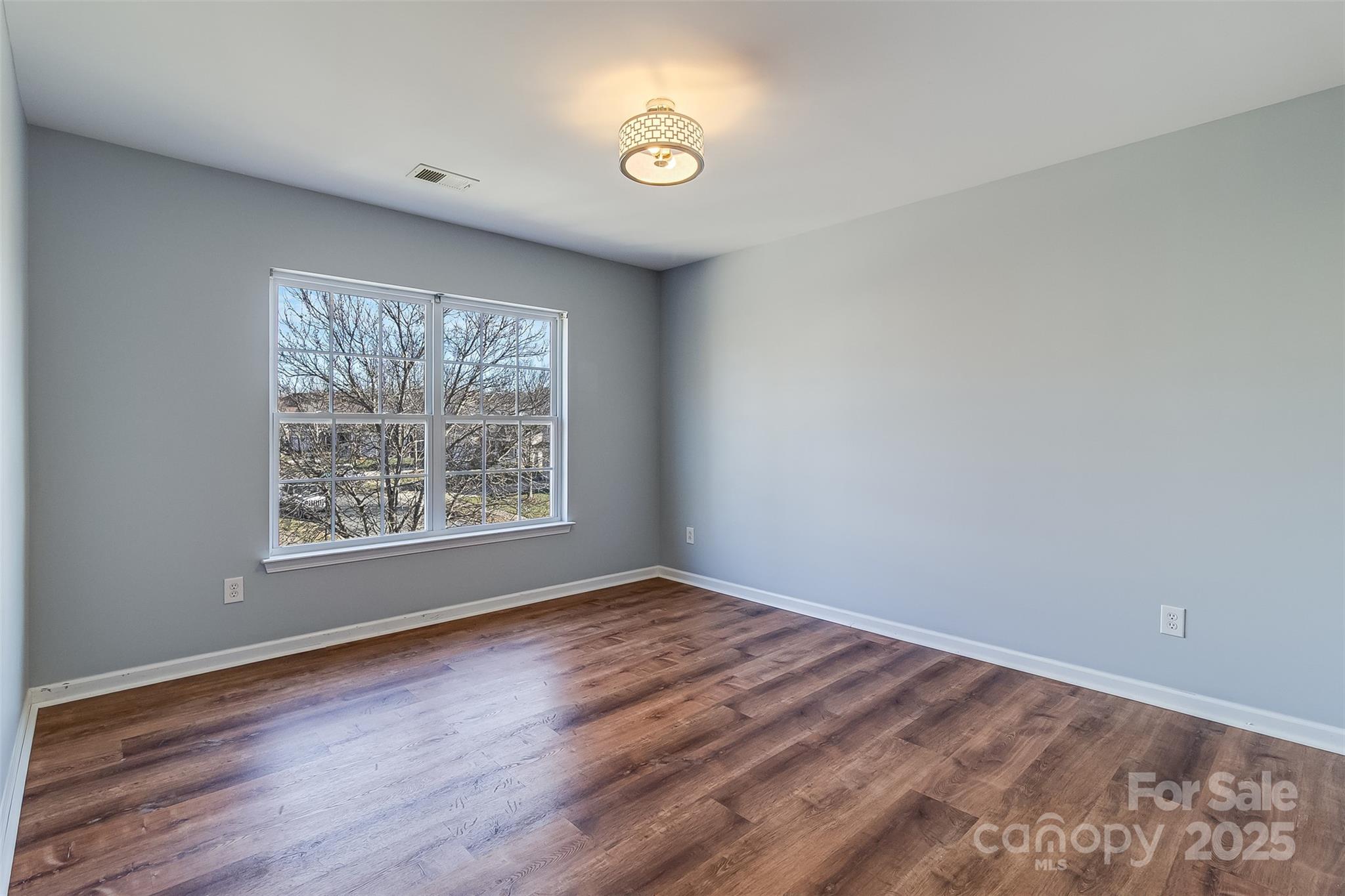 224 Morning Dew Lane Mount Holly, NC 28120 - Photo 34 of 48 an empty room with wooden floor and windows