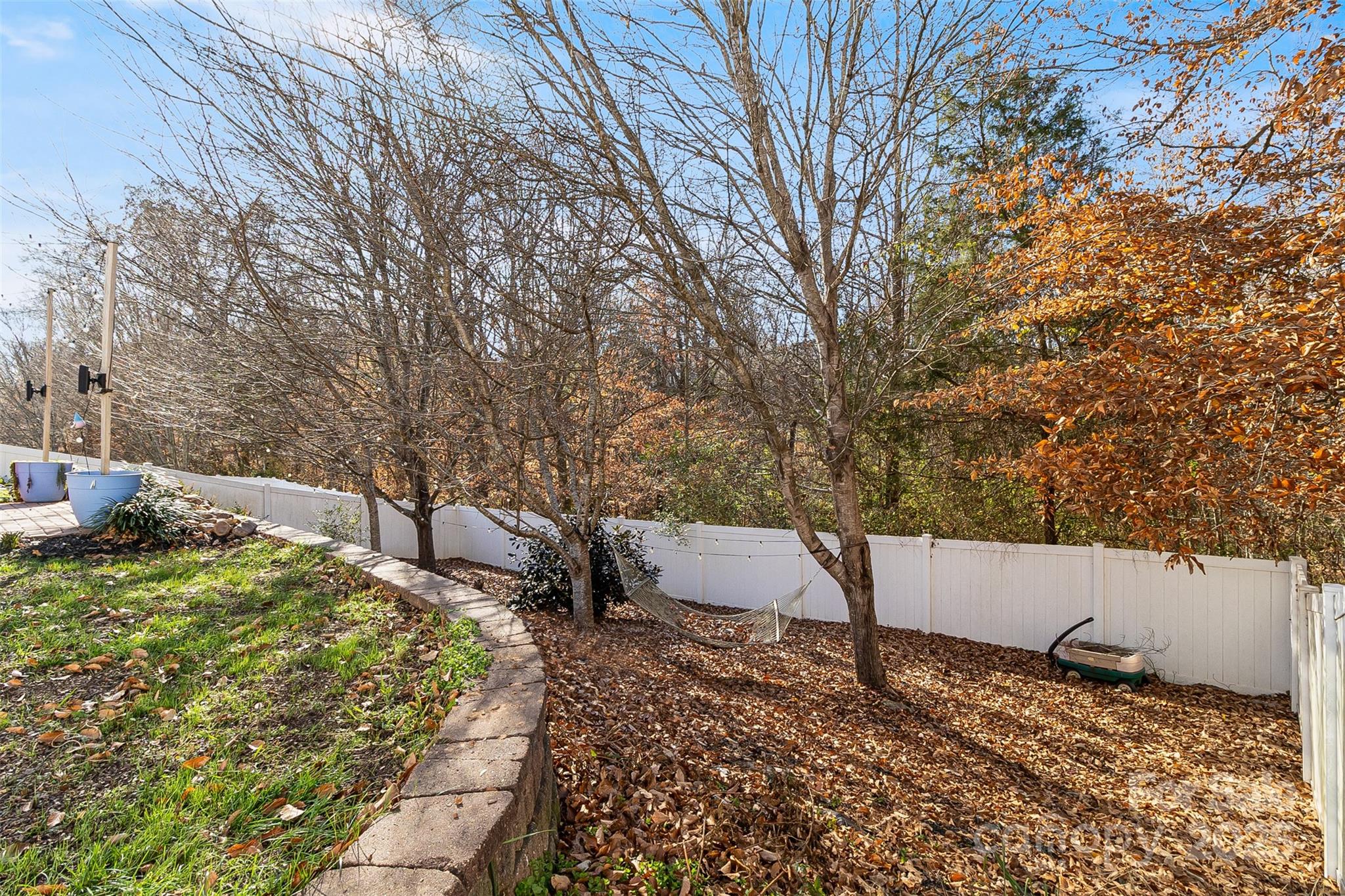 224 Morning Dew Lane Mount Holly, NC 28120 - Photo 6 of 48 a view of a backyard with wooden fence and large trees