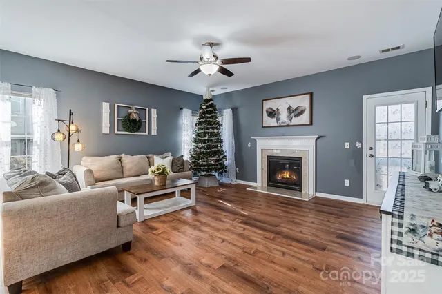 a living room with furniture and a large mirror