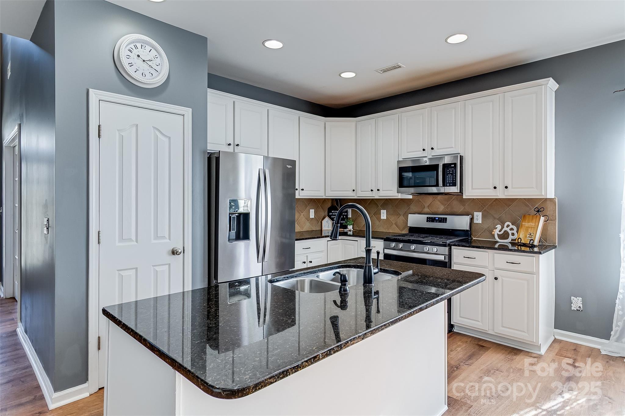 224 Morning Dew Lane Mount Holly, NC 28120 - Photo 8 of 48 a kitchen with stainless steel appliances granite countertop a refrigerator a stove a sink and a microwave