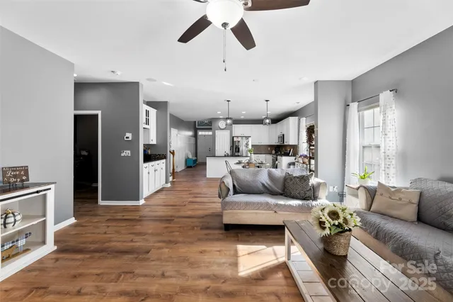 a living room with furniture and kitchen view