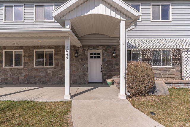 1045 Fox Farm Road Logan, UT 84321 - Photo 2 of 65 Property entrance featuring covered porch, stone siding, and a lawn