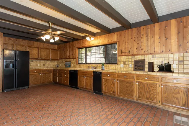 a view of a door of the house with a door and wooden floor