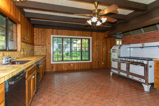 a kitchen with stainless steel appliances granite countertop a sink and cabinets