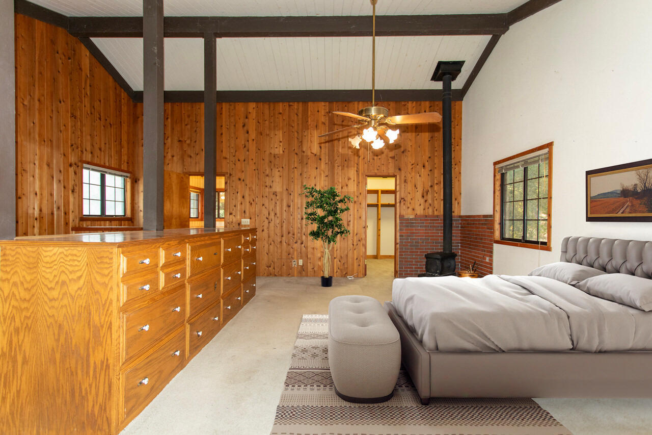 4260 Oak View Road Santa Ynez, CA 93460 - Photo 23 of 98 a bedroom with a large bed and a chandelier