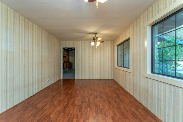 a bed sitting in a room next to a window