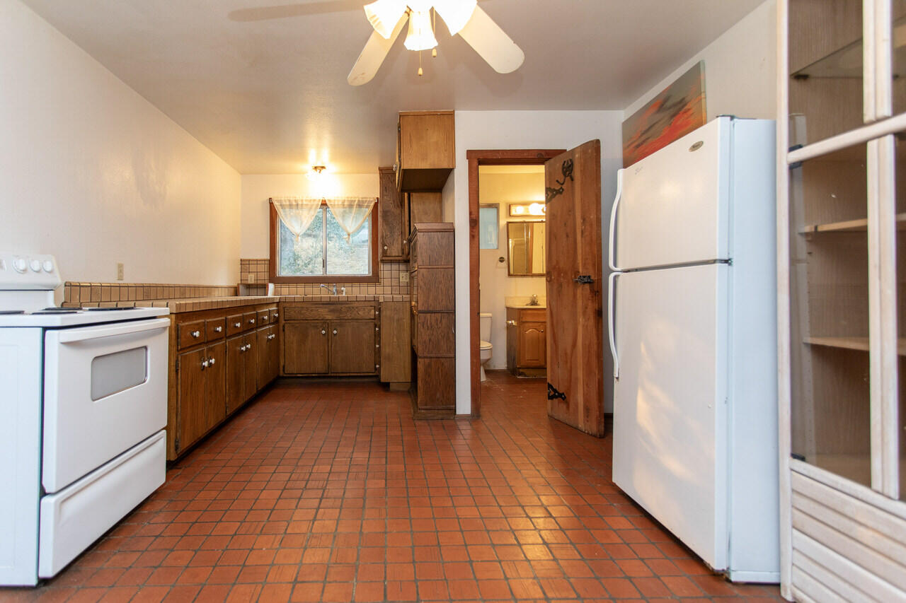4260 Oak View Road Santa Ynez, CA 93460 - Photo 89 of 98 a kitchen with stainless steel appliances a refrigerator a sink and wooden floors