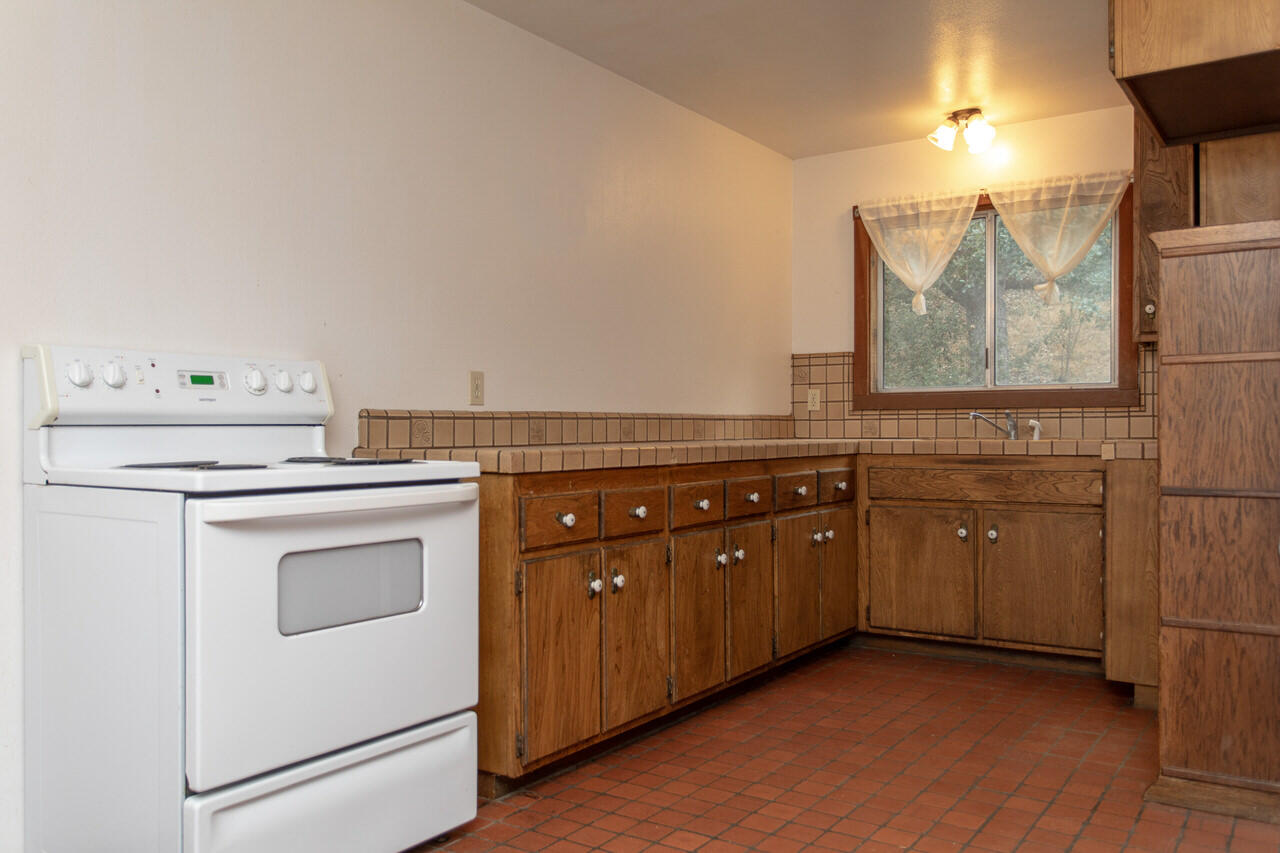 4260 Oak View Road Santa Ynez, CA 93460 - Photo 90 of 98 a kitchen with a stove top oven sink and cabinets