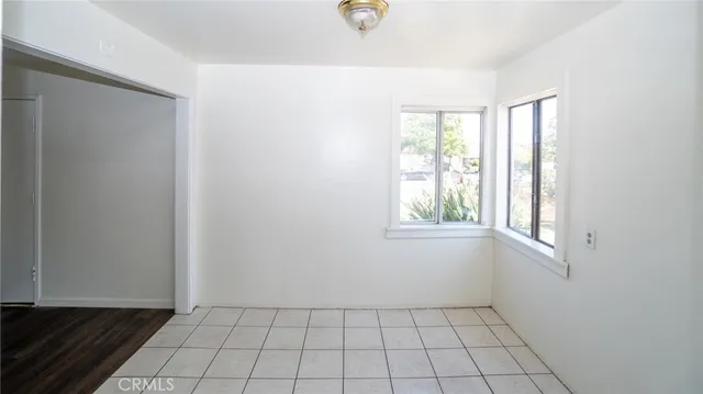 a backyard of a house with table and chairs under an umbrella