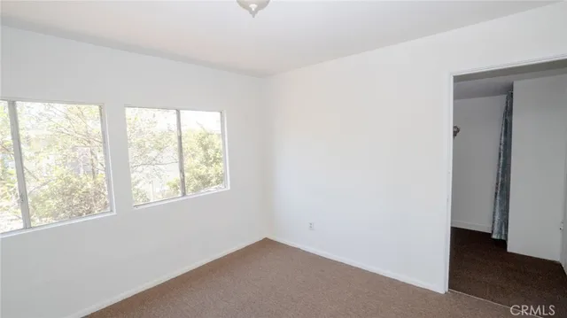 a front view of a house with a yard covered in snow