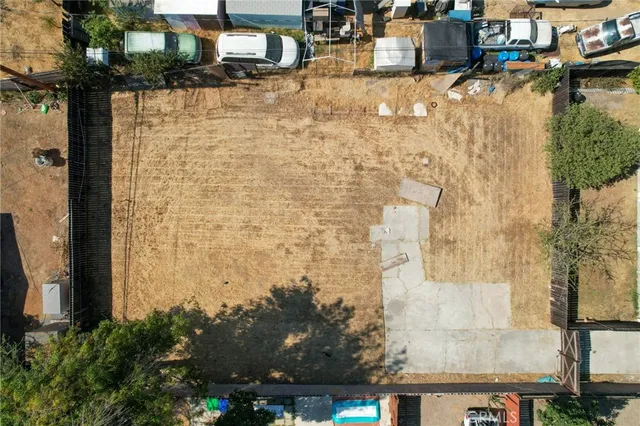 a backyard of a house with plants and tree