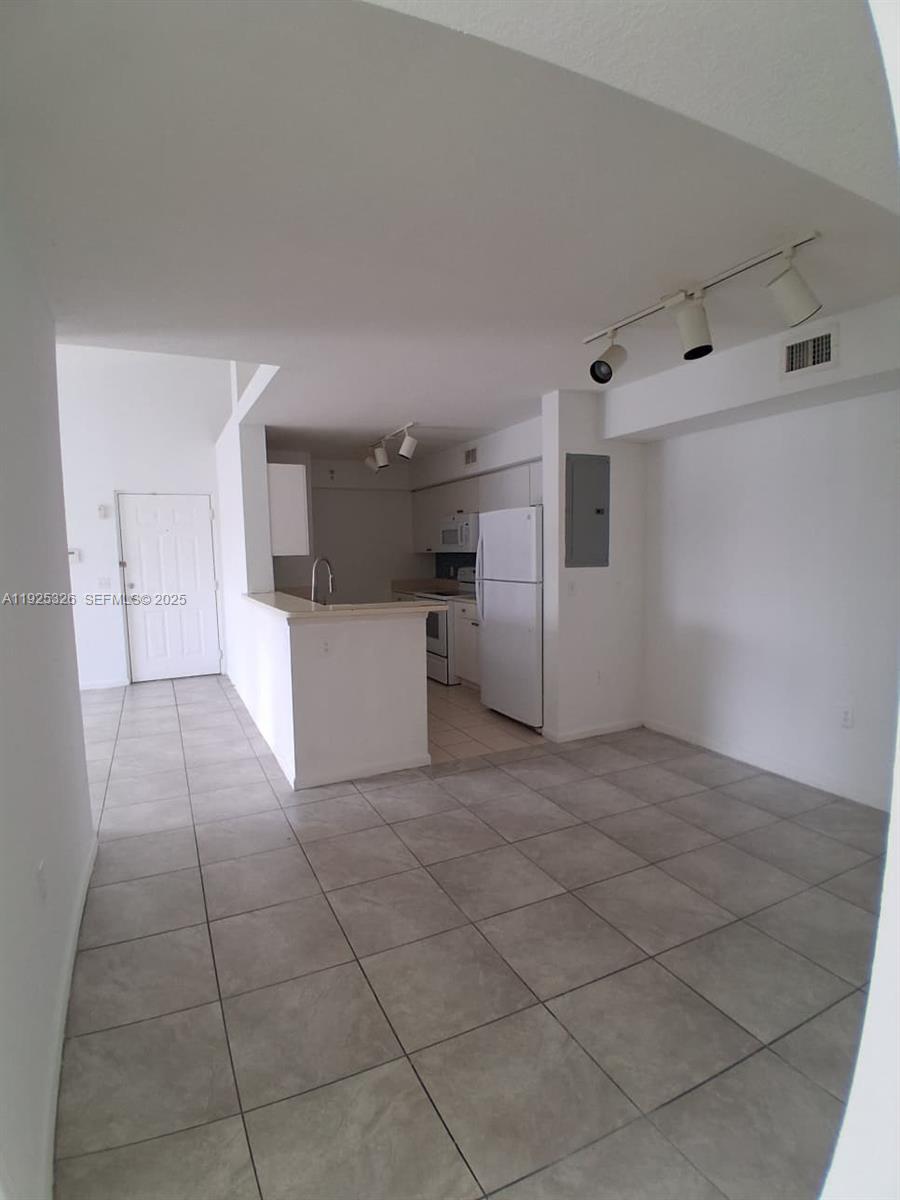 15460 Southwest 284th Street, Unit 4307 Homestead, FL 33033 - Photo 3 of 13 a view of a kitchen with a dishwasher and a refrigerator in it