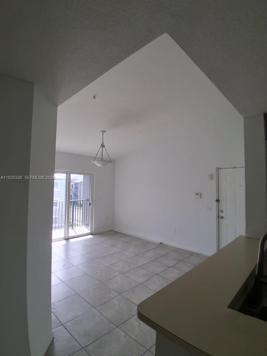 15460 Southwest 284th Street, Unit 4307 Homestead, FL 33033 - Photo 5 of 13 a view of a hallway to a room with stairs