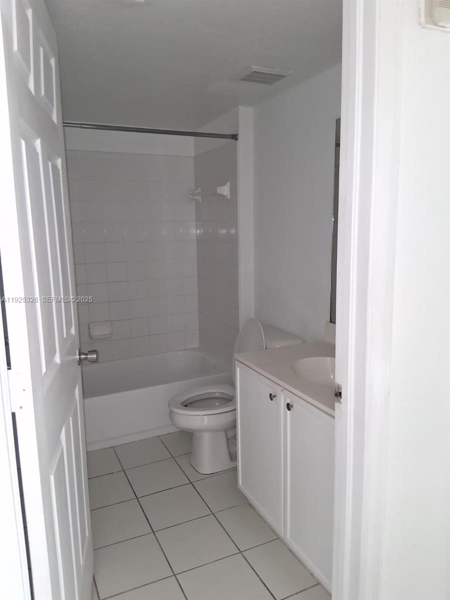 15460 Southwest 284th Street, Unit 4307 Homestead, FL 33033 - Photo 8 of 13 a bathroom with a granite countertop sink a toilet and shower