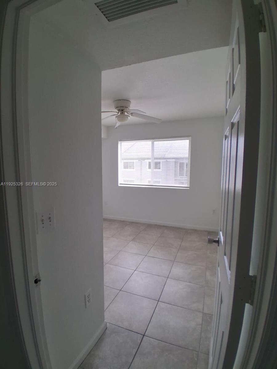 15460 Southwest 284th Street, Unit 4307 Homestead, FL 33033 - Photo 9 of 13 a view of an empty room with a window