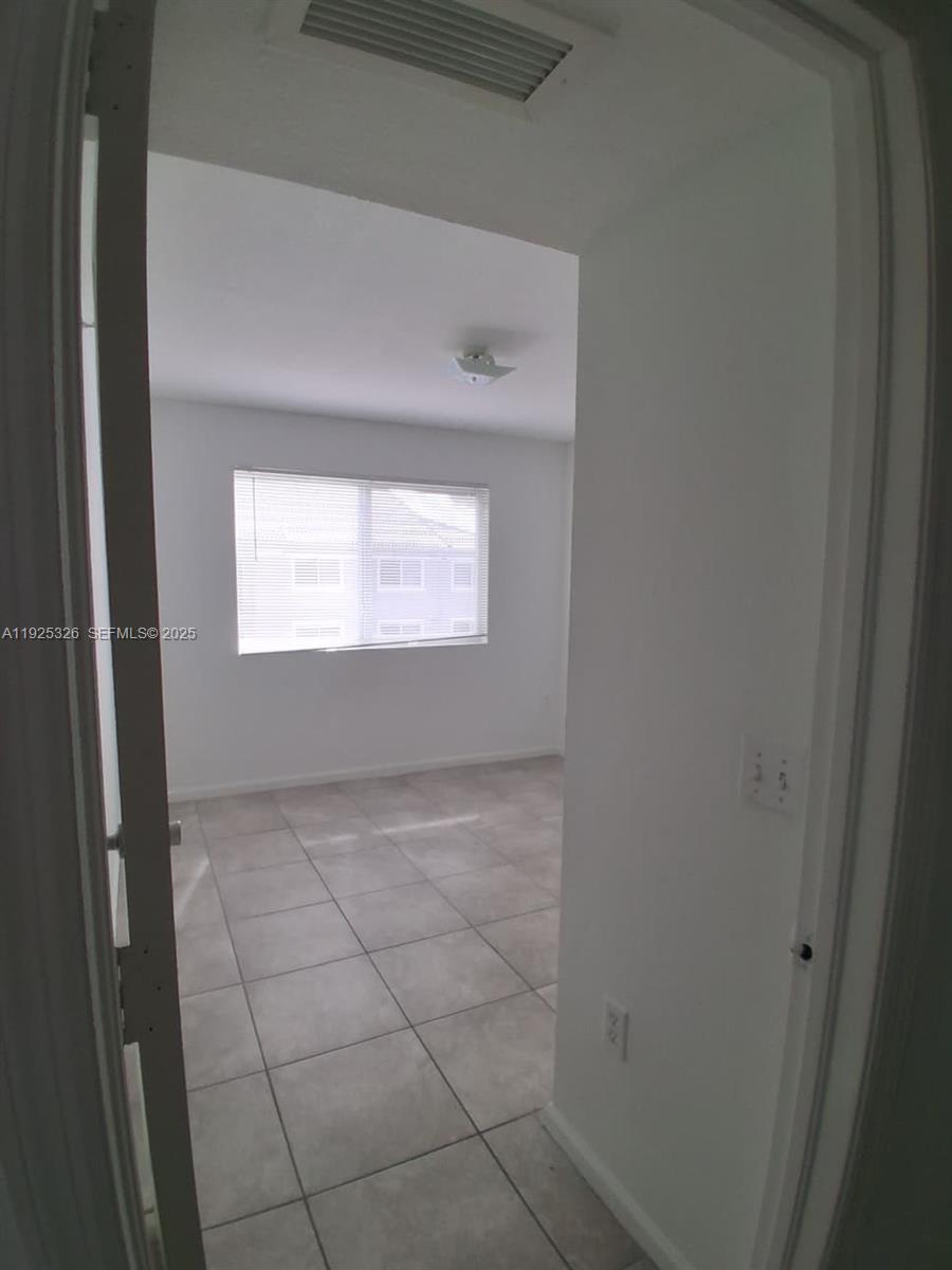 15460 Southwest 284th Street, Unit 4307 Homestead, FL 33033 - Photo 10 of 13 a view of an empty room with a window