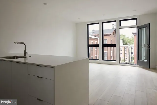 a kitchen with sink cabinets and appliances