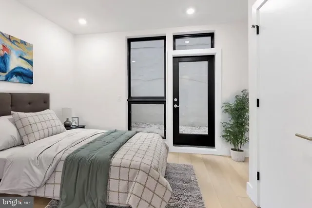 a bedroom with a bed and a painting on the wall