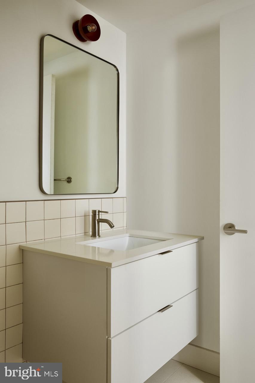 2007 Cambridge Street Philadelphia, PA 19130 - Photo 25 of 33 a bathroom with a sink and a mirror