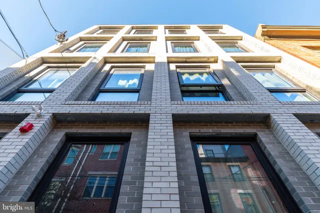a view of a brick house with plants