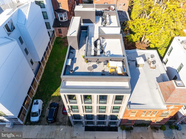 a kitchen with a refrigerator stove and white cabinets
