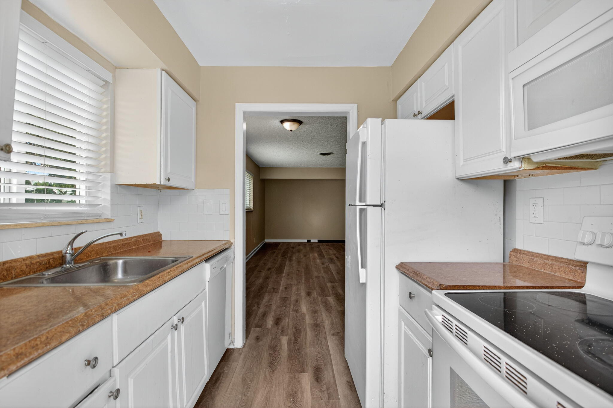 2925 Northeast 7th Avenue, Unit A Pompano Beach, FL 33064 - Photo 1 of 14 a kitchen with a sink and a refrigerator
