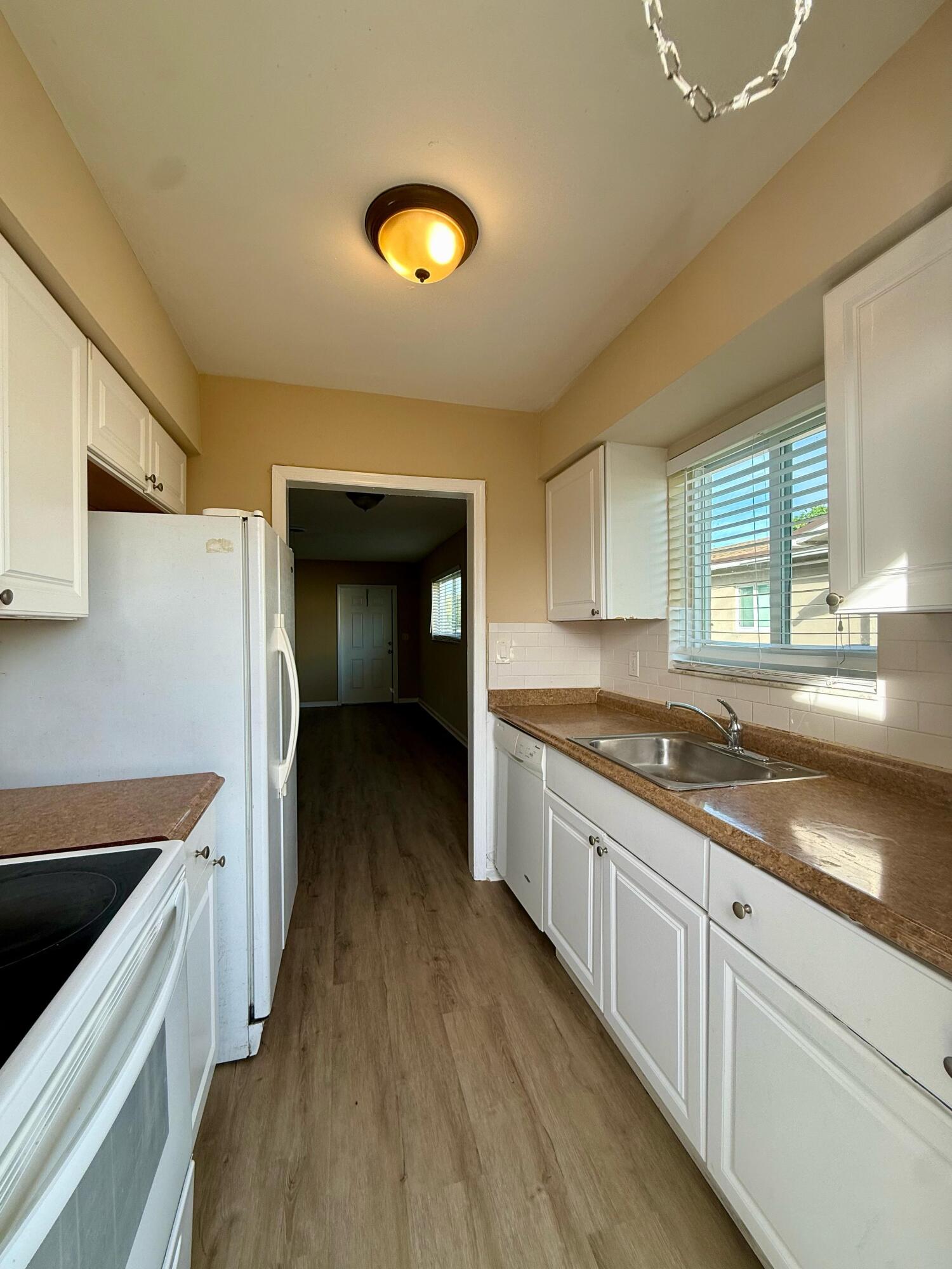 2925 Northeast 7th Avenue, Unit A Pompano Beach, FL 33064 - Photo 14 of 14 a kitchen with a sink and wooden floor