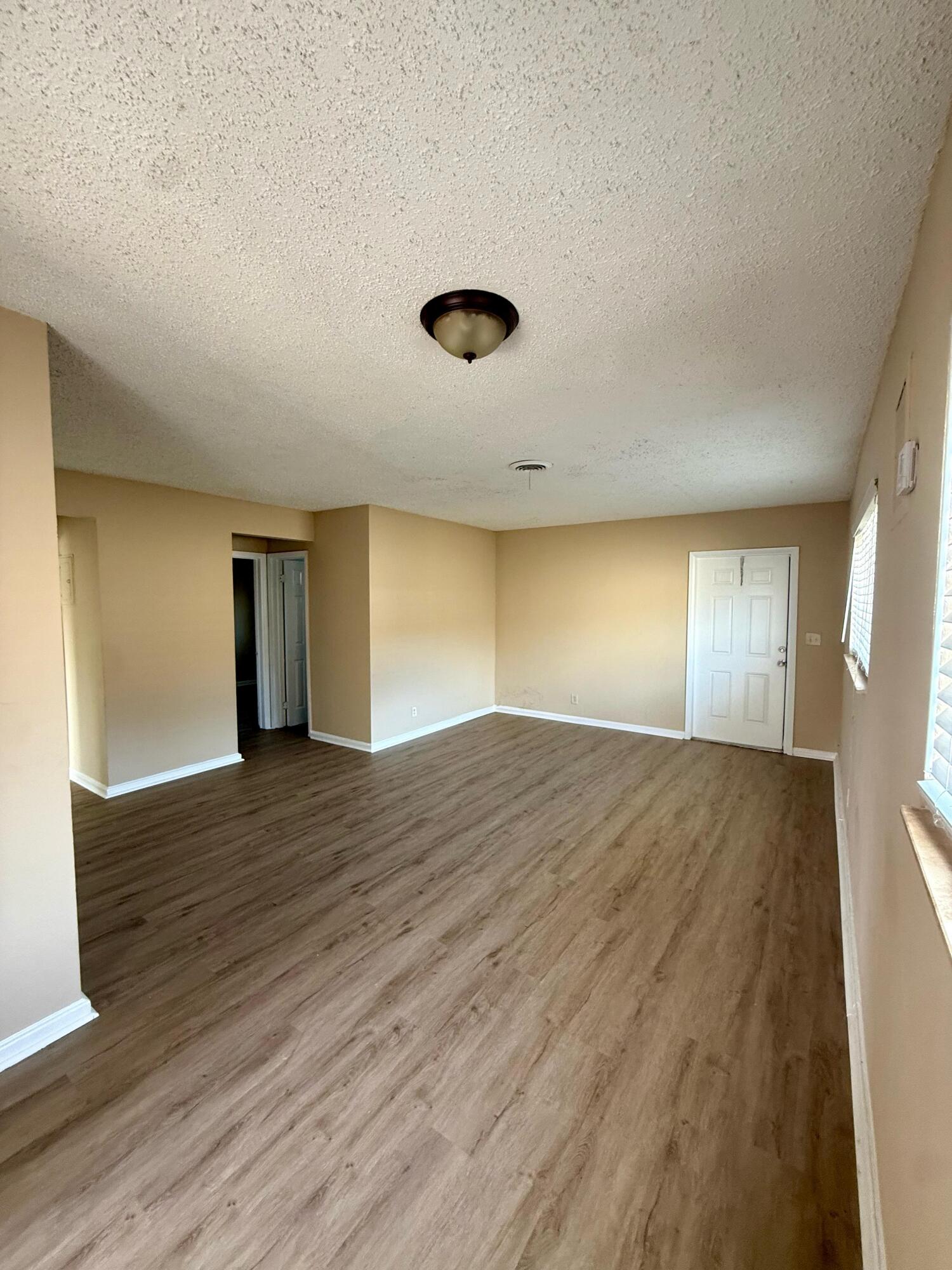 2925 Northeast 7th Avenue, Unit A Pompano Beach, FL 33064 - Photo 2 of 14 a view of empty room with wooden floor