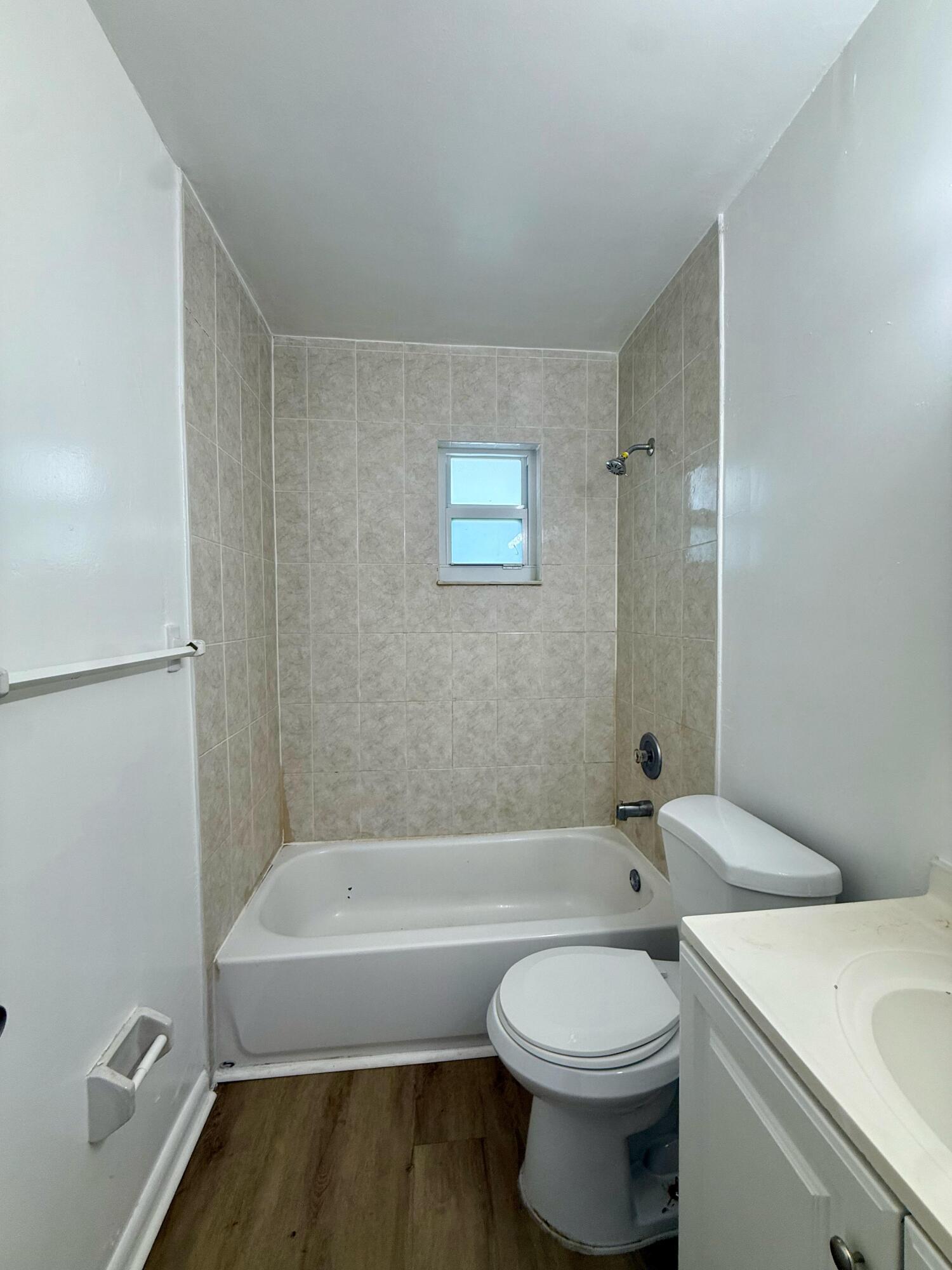 2925 Northeast 7th Avenue, Unit A Pompano Beach, FL 33064 - Photo 5 of 14 a bathroom with a toilet and a bathtub